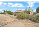 Charming single-story home featuring desert landscaping, native plants, and a light-colored facade at 15534 W Big Sky Dr, Surprise, AZ 85374