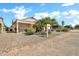 This home features a well-manicured desert front yard, a covered carport, and mature landscaping at 15534 W Big Sky Dr, Surprise, AZ 85374