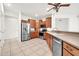 This kitchen features modern stainless steel appliances, wooden cabinetry, and tile floors at 15534 W Big Sky Dr, Surprise, AZ 85374