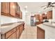 Charming kitchen features wooden cabinets, tile flooring, and stainless steel appliances at 15534 W Big Sky Dr, Surprise, AZ 85374