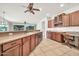 Well-lit kitchen features wooden cabinetry, ample counter space and backyard views at 15534 W Big Sky Dr, Surprise, AZ 85374