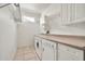 Functional laundry room equipped with washer, dryer, and storage shelves at 15534 W Big Sky Dr, Surprise, AZ 85374