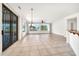 Bright and airy living room featuring neutral tile flooring, large windows, and modern ceiling fans at 15534 W Big Sky Dr, Surprise, AZ 85374