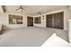 Spacious covered patio featuring tile flooring, decorative ironwork on the doors, and access to the outdoors at 15534 W Big Sky Dr, Surprise, AZ 85374