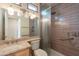 Modern bathroom featuring an updated vanity, framed mirror, and tiled walk-in shower with grab bars at 1555 E Monterey St, Chandler, AZ 85225
