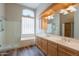 Bathroom with a double vanity, shower, and soaking tub with a window providing natural light at 1555 E Monterey St, Chandler, AZ 85225