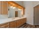 Bathroom featuring a double vanity, large mirror, and wood cabinets at 1555 E Monterey St, Chandler, AZ 85225