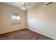 Bedroom with neutral carpet, ceiling fan, and a window providing natural light at 1555 E Monterey St, Chandler, AZ 85225