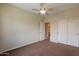 Bedroom with neutral carpet, ceiling fan, and a standard closet at 1555 E Monterey St, Chandler, AZ 85225