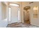 Bright foyer with wood-look tile, arched doorways, and abundant natural light at 1555 E Monterey St, Chandler, AZ 85225