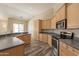 Functional kitchen featuring updated appliances, ample counter space, and wood-look tile at 1555 E Monterey St, Chandler, AZ 85225