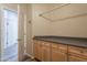 Spacious laundry room with wood-look floors, cabinets and countertop space at 1555 E Monterey St, Chandler, AZ 85225