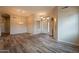 Open-concept living room with wood-look tile, recessed lighting, and adjacent dining area at 1555 E Monterey St, Chandler, AZ 85225