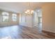 Bright living room featuring wood-look tile, updated lighting, and large windows at 1555 E Monterey St, Chandler, AZ 85225