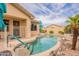 Beautiful backyard pool with stone accents, rock features, and shade umbrellas at 1555 E Monterey St, Chandler, AZ 85225