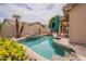 Backyard pool has rock features, palm trees, and is fully fenced at 1555 E Monterey St, Chandler, AZ 85225