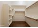 Walk-in closet featuring built in shelving and wooden racks for ample storage at 1555 E Monterey St, Chandler, AZ 85225