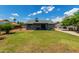 Green backyard with a patio area and nearby houses at 161 S Maple St, Chandler, AZ 85226