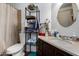 Bathroom with a vanity, sink, metal shelving unit, and mirror at 161 S Maple St, Chandler, AZ 85226