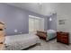 Bedroom with tile flooring, two beds, ceiling fan, and neutral walls at 161 S Maple St, Chandler, AZ 85226