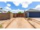 View of the driveway, two-car garage, privacy gate, and xeriscaped front yard, perfect for curb appeal at 161 S Maple St, Chandler, AZ 85226