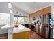 Bright kitchen features stainless steel appliances, light wood cabinets and a breakfast bar at 161 S Maple St, Chandler, AZ 85226
