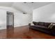 Neutral toned living room with a brown couch, and stained concrete floors at 161 S Maple St, Chandler, AZ 85226