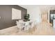 Bright dining room features a modern table, stylish chairs, and wood-look tile flooring at 17345 W Smoketree Dr, Surprise, AZ 85387