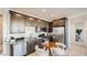 Compact kitchen with stainless steel appliances, granite countertops, and a cozy dining nook at 17345 W Smoketree Dr, Surprise, AZ 85387