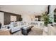 Inviting living room with white sofa, modern decor, and seamless flow to the kitchen at 17345 W Smoketree Dr, Surprise, AZ 85387
