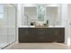 Sleek bathroom featuring double vanity, modern fixtures, and glass shower at 17348 W Smoketree Dr, Surprise, AZ 85387