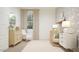 Bright Bedroom featuring neutral decor, a round crib, dresser, oval mirror and a comfortable rocking chair at 17348 W Smoketree Dr, Surprise, AZ 85387