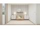 Well-lit Bedroom with cloud wallpaper, complemented by a crib, neutral furniture, and a decorative shelf at 17348 W Smoketree Dr, Surprise, AZ 85387