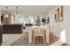 Bright dining room featuring modern lighting, a white table, and natural wood chairs at 17348 W Smoketree Dr, Surprise, AZ 85387