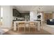 Cozy dining area featuring a white table, wooden chairs, and adjacent kitchen at 17348 W Smoketree Dr, Surprise, AZ 85387