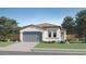 Charming single-story home with a two-car garage and well-manicured lawn at 17348 W Smoketree Dr, Surprise, AZ 85387