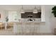Well-lit kitchen with stainless steel appliances, modern lighting, and a breakfast bar at 17348 W Smoketree Dr, Surprise, AZ 85387