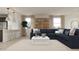 Comfortable living room featuring a plush navy sofa and natural light from bright windows at 17348 W Smoketree Dr, Surprise, AZ 85387
