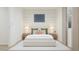 Stylish main bedroom features neutral decor, bedside tables, a comfortable bed, and a decorative wall piece at 17348 W Smoketree Dr, Surprise, AZ 85387