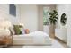Bright main bedroom features a large window, comfortable bed and chic decor creating a relaxing atmosphere at 17348 W Smoketree Dr, Surprise, AZ 85387
