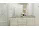 This bathroom features a white dual vanity and a glass shower enclosure, perfect for modern living at 17349 W Smoketree Dr, Surprise, AZ 85387