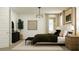 Comfortable bedroom features neutral decor, a plush bed and plenty of natural light at 17349 W Smoketree Dr, Surprise, AZ 85387
