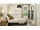 Bright bedroom with a modern design, featuring a potted plant and stylish wall decor at 17349 W Smoketree Dr, Surprise, AZ 85387
