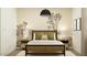 Stylized bedroom featuring a desert-themed mural, matching side tables and sleek lamps at 17349 W Smoketree Dr, Surprise, AZ 85387