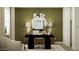 Stylish home office with modern decor, desk, accent wall, and ample natural light at 17349 W Smoketree Dr, Surprise, AZ 85387