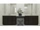 Modern bathroom featuring dark wood cabinets, dual sinks, and a central vanity area with decorative plant at 17403 W Swayback Pass, Surprise, AZ 85387