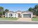 Charming single-story home with a neutral color scheme, a well-manicured lawn, and an attached two-car garage at 17403 W Swayback Pass, Surprise, AZ 85387