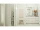 Bright bathroom with white cabinets, decorative vase and modern vanity at 17411 W Swayback Pass, Surprise, AZ 85387