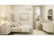 Relaxing bedroom with soft colors, cozy bedding, and a bright window at 17411 W Swayback Pass, Surprise, AZ 85387