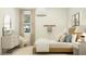 This bedroom features a well lit window, neutral decor, and a sleek mid-century modern dresser at 17411 W Swayback Pass, Surprise, AZ 85387